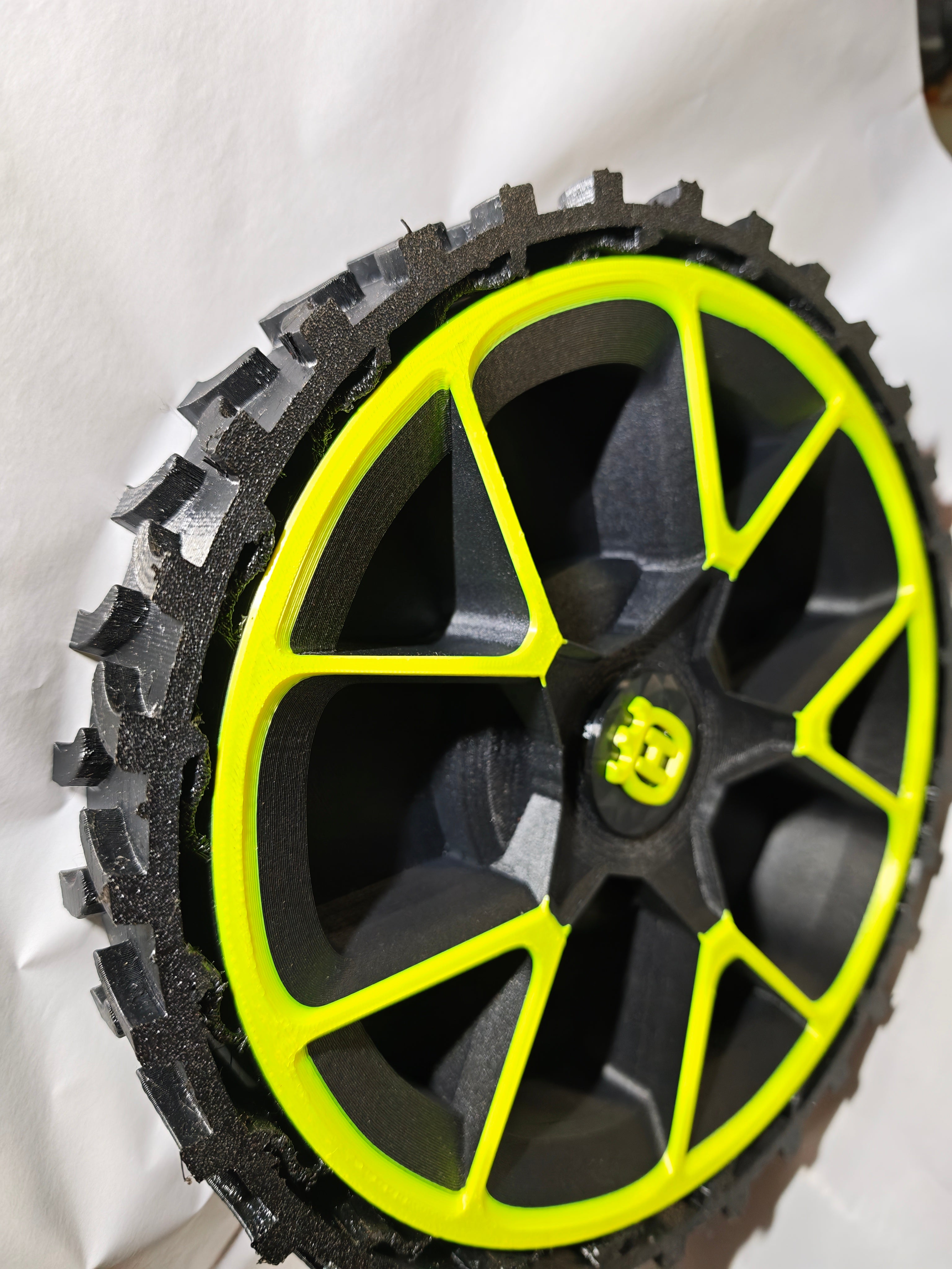 Wheel with yellow rim and black tread on a white background